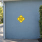 Yellow road sign sticker with black border, diamond shape, text "DEAD END"