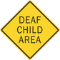 Road sign sticker, yellow diamond with black border and 'DEAF CHILD AREA' text