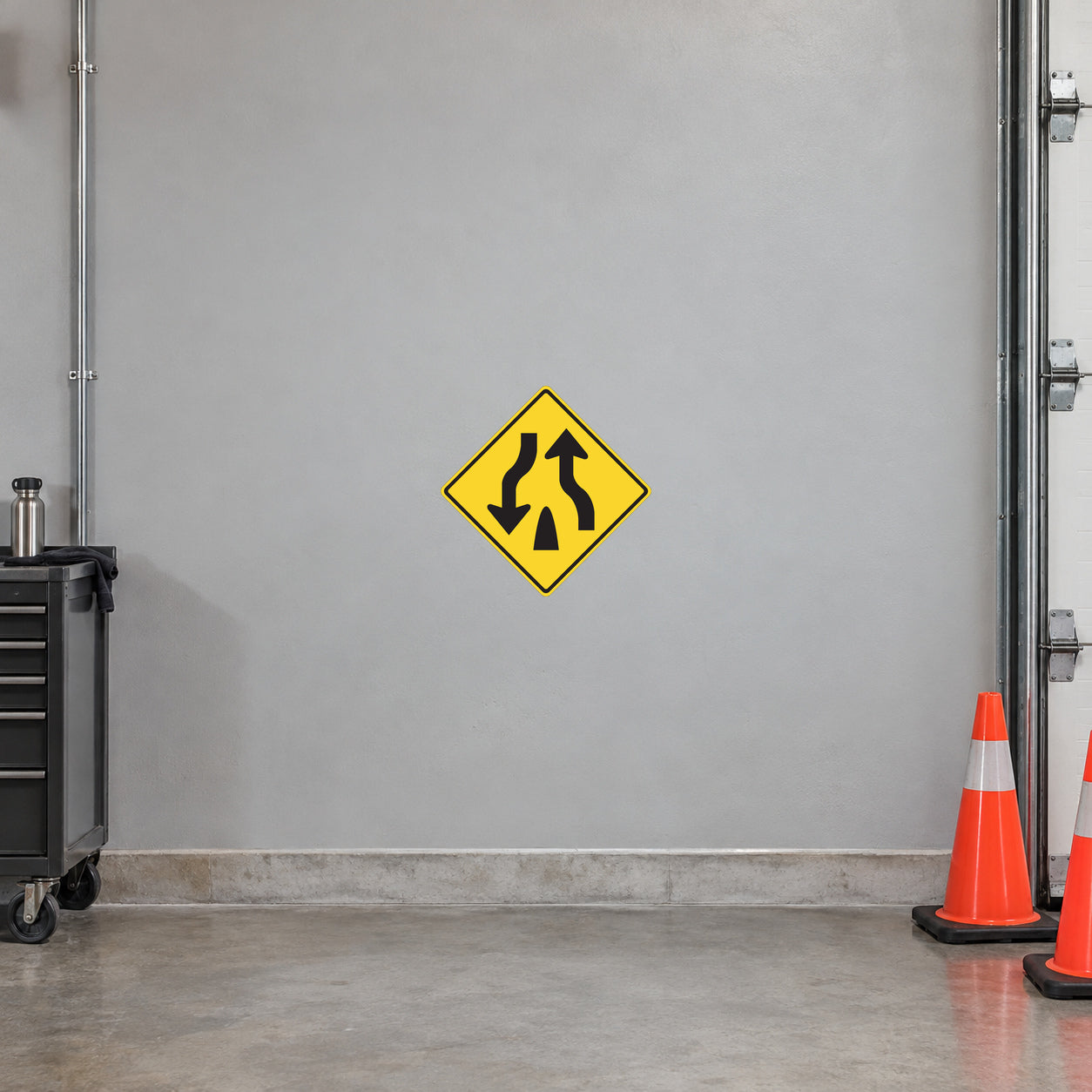 Road sign sticker: yellow diamond with black upward and downward arrows