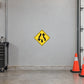 Road sign sticker: yellow diamond with black upward and downward arrows