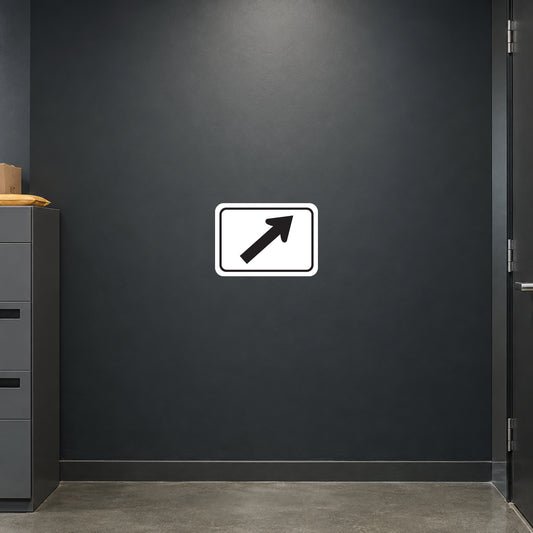 Road Sign Sticker applied in A dark slate office loading corridor wall with parcel bins low left and metal door edge far right, smooth blank center