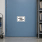 Road Sign Sticker applied in A muted blue fleet planning office flat metal storage door with route folder shelf at far right and trolley far left, blank central door
