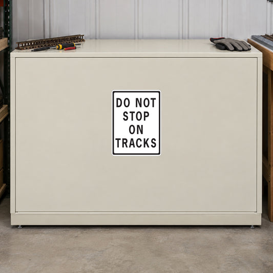 Road Sign Sticker applied in A cream railway maintenance workshop single flat storage cabinet with model track tool low left and rail glove far right, blank smooth front