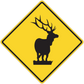 Yellow road sign sticker with black deer silhouette in diamond border