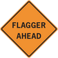 Orange road sign sticker with black border reading FLAGGER AHEAD