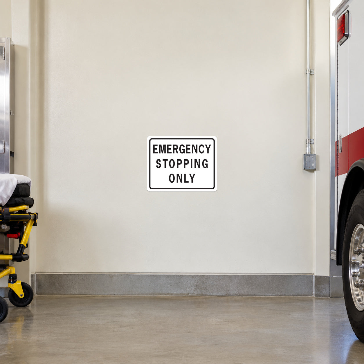 Road sign sticker: 'EMERGENCY STOPPING ONLY' black text on white with black border