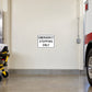 Road sign sticker: 'EMERGENCY STOPPING ONLY' black text on white with black border