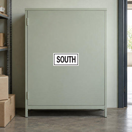 Road Sign Sticker applied in A pale sage commercial loading room smooth cabinet with sealed cartons low left and doorway extreme right, blank single front