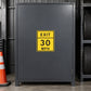 Road Sign Sticker applied in A charcoal fleet garage smooth steel locker beside traffic cone far left and tyre rack far right, blank central door