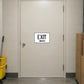 Road Sign Sticker applied in A cream commercial store back corridor smooth door with carton stack extreme right and mop bucket far left, central blank single surface
