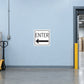 Road Sign Sticker applied in A pale blue warehouse receiving entry smooth wall with pallet jack far left and doorway far right, blank center