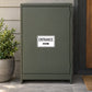 Road Sign Sticker applied in A dark sage business service entry cabinet with parcel shelf extreme right and potted plant low left, single blank smooth door