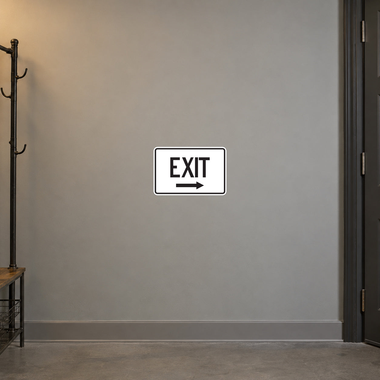 Road Sign Sticker applied in A warm grey workshop corridor smooth wall with empty coat rack extreme left and door edge right, blank center