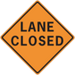 Road sign sticker: orange diamond with black border, 'LANE CLOSED' text