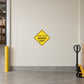 Road Sign Sticker applied in A pale cream delivery depot wayfinding wall with warehouse bay edge far left and pallet jack low right, smooth blank center