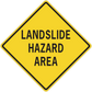 Yellow road sign sticker, black border diamond reading “LANDSLIDE HAZARD AREA”