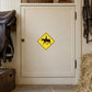 Road Sign Sticker applied in An equestrian stable tack room, one smooth cream painted wooden cupboard door, leather saddle at extreme left and hay at bottom right