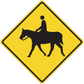 Yellow road sign sticker with black rider-on-horse silhouette in diamond frame
