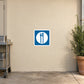 Road Sign Sticker applied in A highway cafe back entrance, uninterrupted warm ivory plaster wall, stainless prep trolley extreme left and potted rosemary extreme right