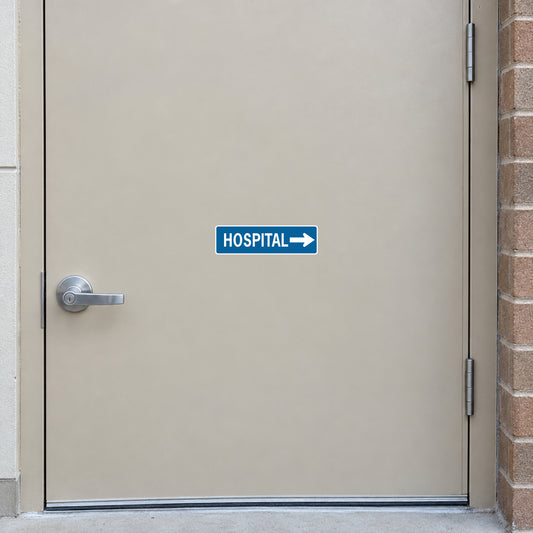 Road sign sticker with blue HOSPITAL text and right arrow