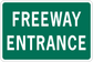 Green freeway entrance road sign sticker with white text, rounded corners