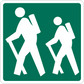 Road sign sticker with white pedestrian crossing symbols on green background