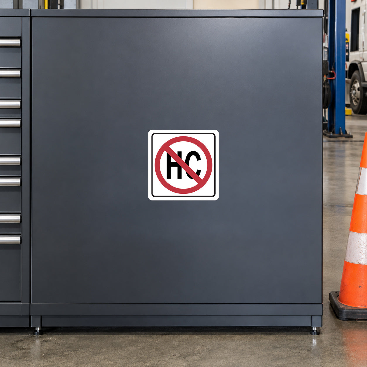 Road Sign Sticker applied in A commercial vehicle service bay, smooth charcoal steel cabinet panel, safety cone extreme right