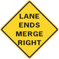 Road sign sticker: yellow diamond with black border and text 'LANE ENDS MERGE RIGHT'.