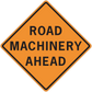 Road sign sticker with orange diamond border and text: ROAD MACHINERY AHEAD