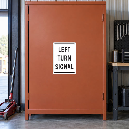 White-bordered road sign sticker reading LEFT TURN SIGNAL