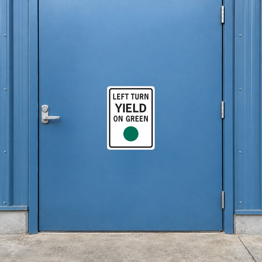 Road sign sticker with 'LEFT TURN YIELD ON GREEN' and green dot