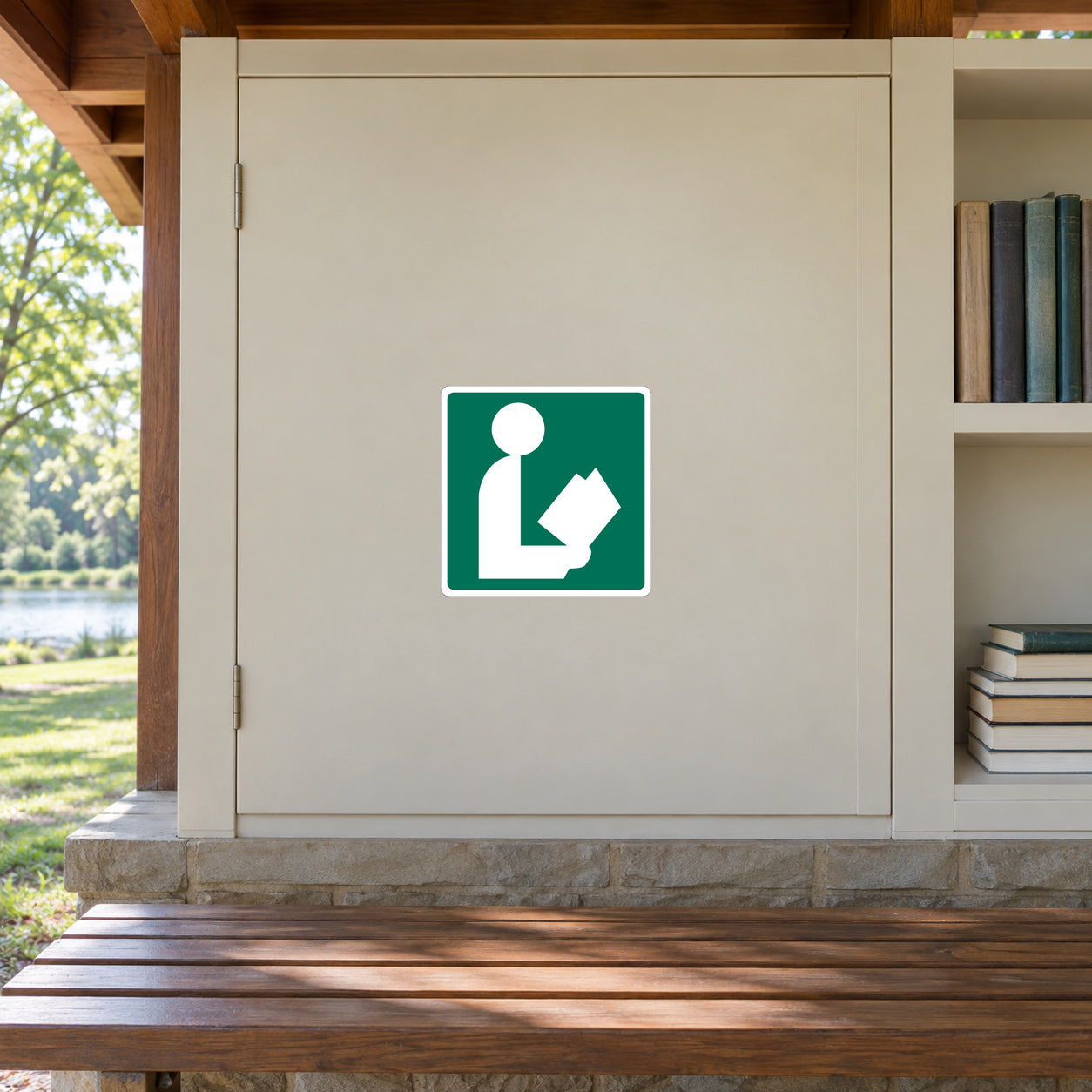 Road Sign Sticker applied in A park reading shelter, smooth cream painted single cupboard door, closed books far right and timber bench below