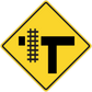 Yellow diamond road sign sticker with black T and dotted crossbar symbol