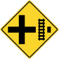 Road sign sticker: yellow diamond with black cross and speed bump style symbol