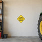 Yellow diamond road sign sticker reading "SLOW VEHICLES AHEAD".