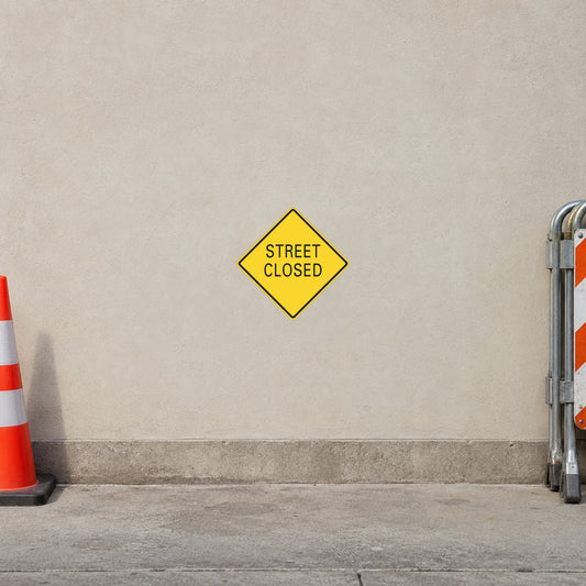 Road sign sticker: yellow diamond, 'STREET CLOSED'.