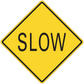 Road sign sticker: yellow diamond with black border and “SLOW” text