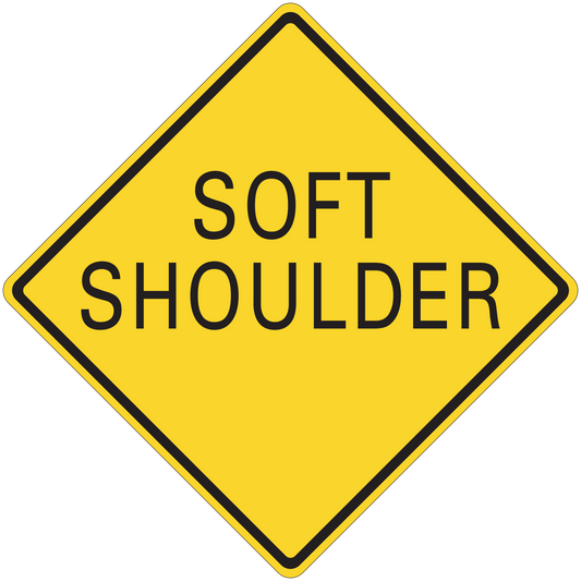 Road sign sticker: yellow diamond with black text "SOFT SHOULDER"