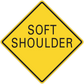 Road sign sticker: yellow diamond with black text "SOFT SHOULDER"
