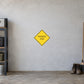 Road sign sticker with yellow diamond reading “PAVEMENT ENDS”