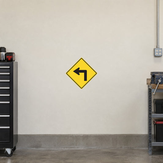 Yellow road sign sticker with left arrow symbol