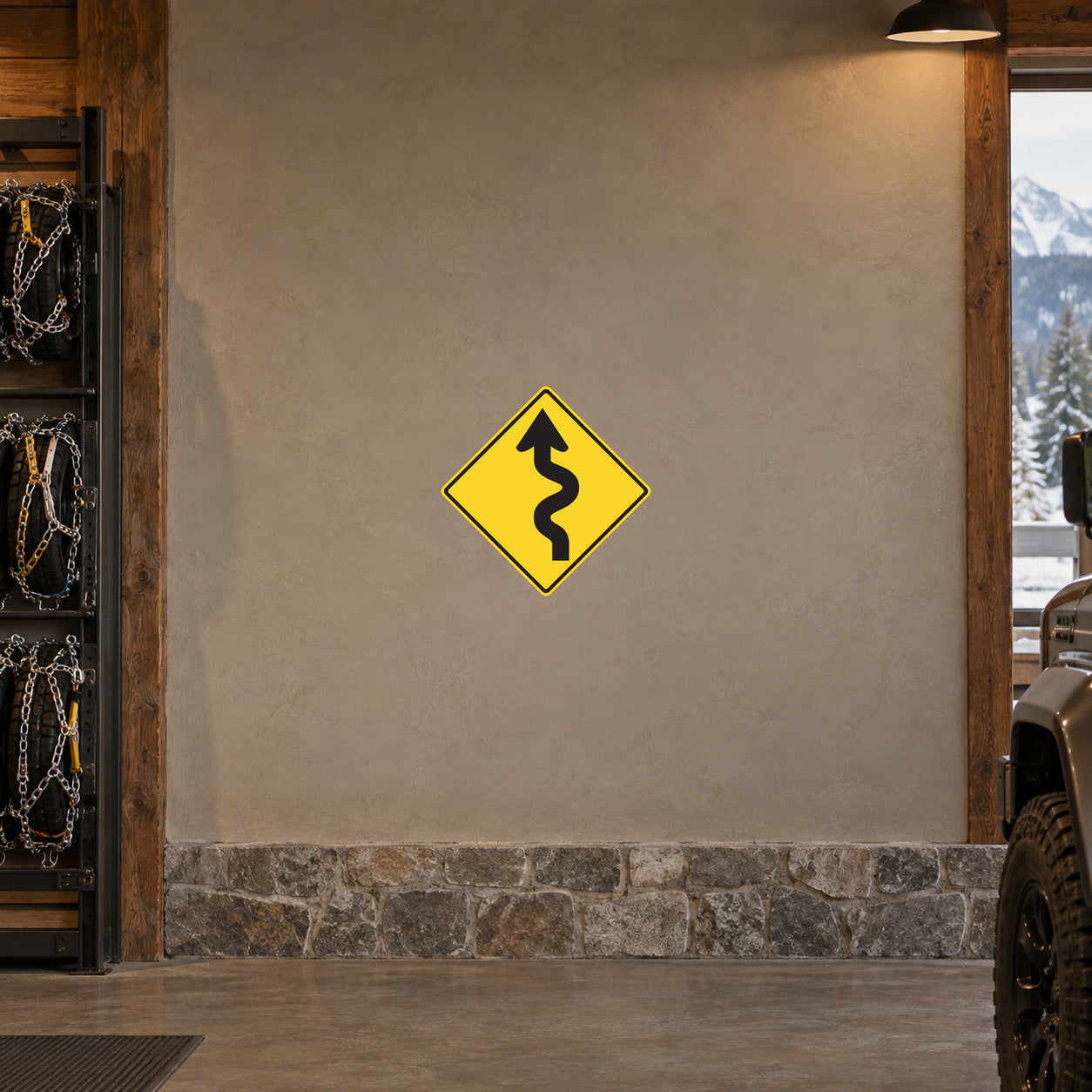 Yellow road warning sticker with black winding-road symbol inside diamond