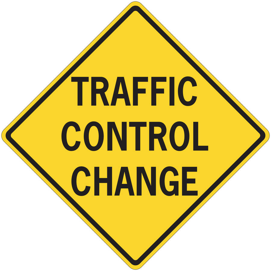 Yellow road sign sticker with black border reading "TRAFFIC CONTROL CHANGE"
