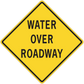 Yellow road sign sticker with black border reading "WATER OVER ROADWAY"