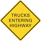 Yellow road sign sticker with black border reading “TRUCKS ENTERING HIGHWAY”