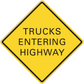 Road sign sticker: yellow diamond with black border, 'TRUCKS ENTERING HIGHWAY'.