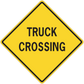 Yellow road sign sticker with black TRUCK CROSSING text in a diamond
