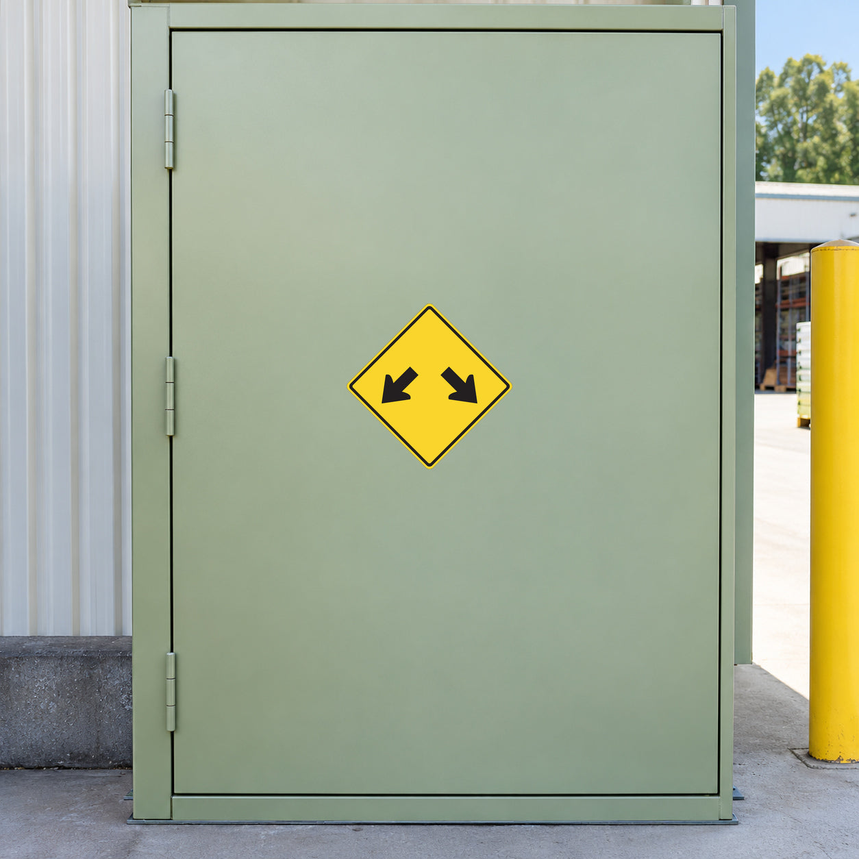 Road Sign Sticker applied in A workshop yard divider entrance, smooth pale green single cabinet door, safety post far right