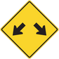 Road sign sticker: yellow diamond with black arrows pointing down left and right