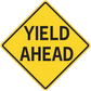 Yellow road sign sticker reading "YIELD AHEAD" with black border